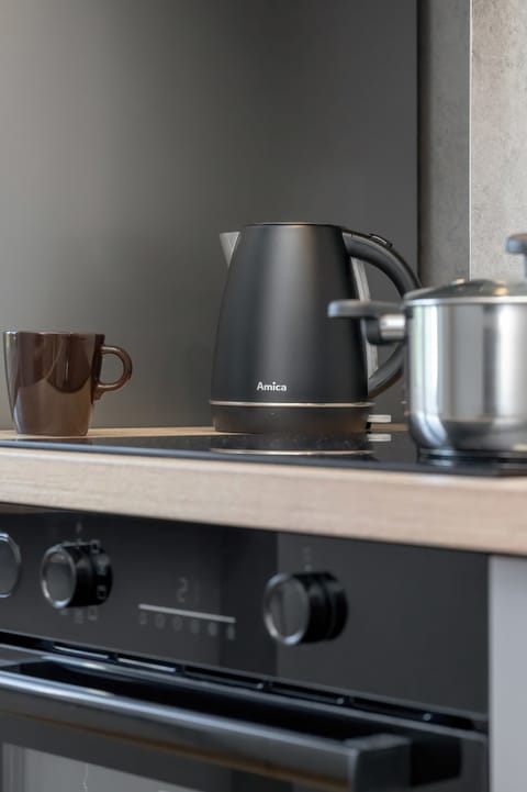 Kitchen details including a kettle and oven. The appliances are modern and functional.