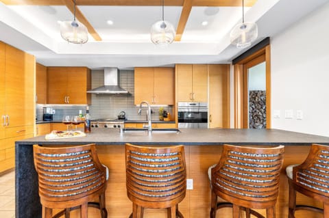 The chef-ready kitchen includes high-end appliances and a bar for casual dining.