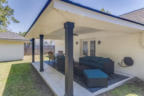 Covered back porch with outdoor seating—ideal for morning coffee or relaxing in the shade.
