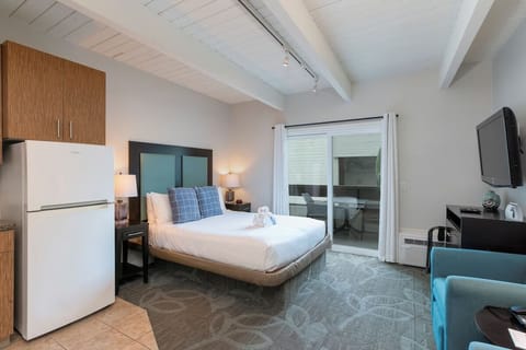 Unwind in a bright king bed retreat with balcony doors.