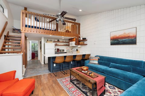 Open kitchen/LR with 2 more kitchen bar chairs stored in the BR closet.