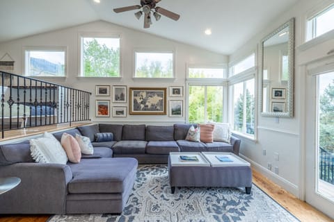 Living room with a comfy sectional and large windows with views