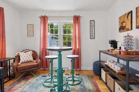Start your day in style—our Sunshine Lounge features a high-top table and unique bike-pedal stools, perfect for morning coffee, family games, or a cozy hangout near Notre Dame.