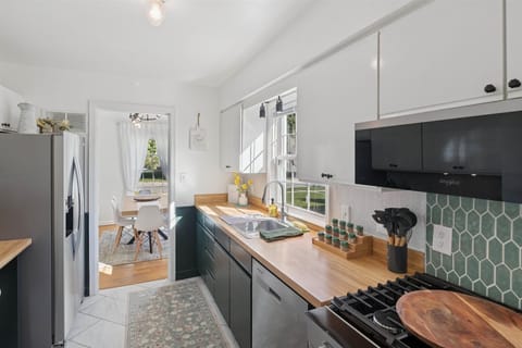 Ready to cook, bake, and gather—our South Bend kitchen features a sleek dishwasher, stainless range, stocked spices, utensils, and a pizza peel for alfresco meals near Notre Dame.