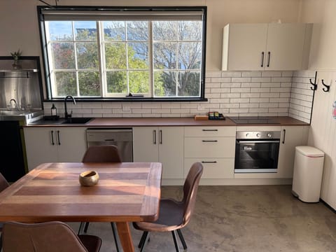 Fully equipped kitchen with oven, cooktop, dishwasher & fridge.