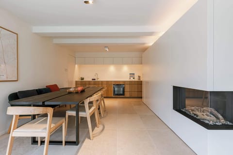 Contemporary dining with wooden chairs for shared conversations.