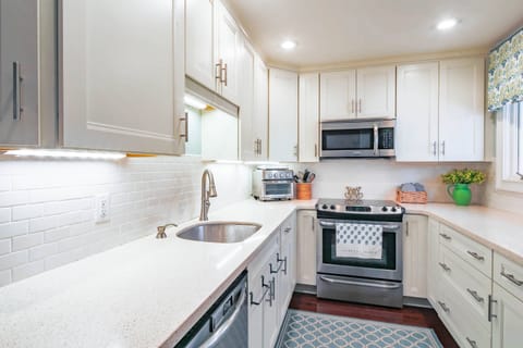 The kitchen features a dishwasher, electric range, microwave and airfyer/toaster oven.