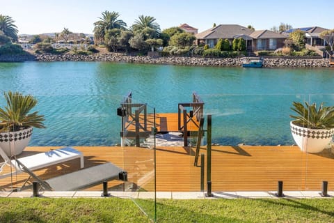 Step from the lawn onto your private pontoon for an early paddle across the glassy lake.