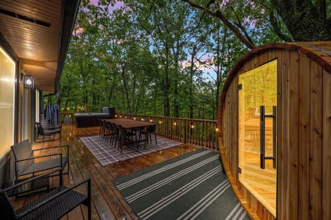 Escape to serenity with our dining space, sauna, and hot tub nestled among the trees.
