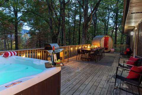 Escape to serenity with our dining space, sauna, and hot tub nestled among the trees.