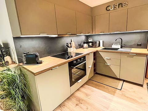 Wood, Flooring, Kitchen, Furniture, Cabinetry, Kitchen Appliance, Countertop, Interior Design, Floor, Home Appliance