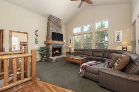 Livingroom w/ sectional couch and fireplace.