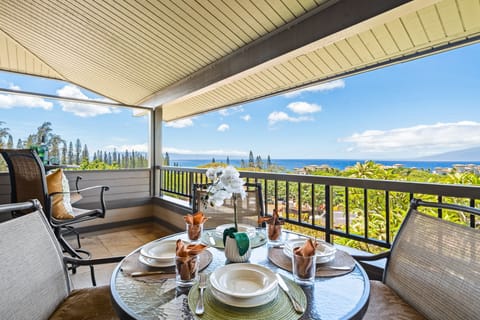 Oceanfront lanai with dining for four and sweeping views of blue waters.