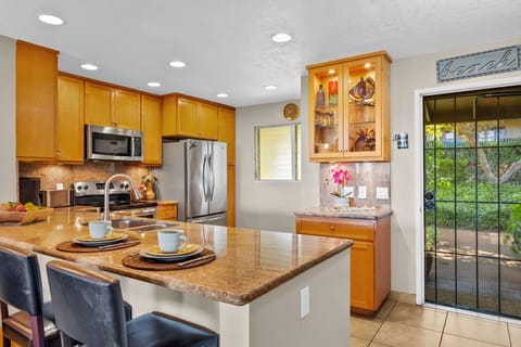 A spacious island with bar seating creates the perfect spot for quick meals or socializing while cooking