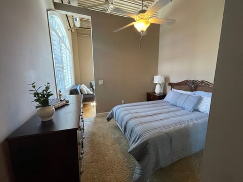 Bright and comfortable bedroom with high ceilings and modern charm — unwind at The Gateway Village in Murfreesboro.