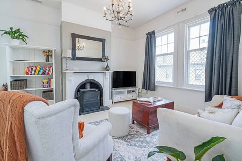 Sink into soft furnishings in the character-filled living room, where modern amenities blend with curated details for a relaxed, stylish stay.