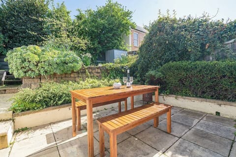 This sunlit corner of the patio invites lazy lounging with a book or wine in hand, surrounded by natural beauty and fresh air.