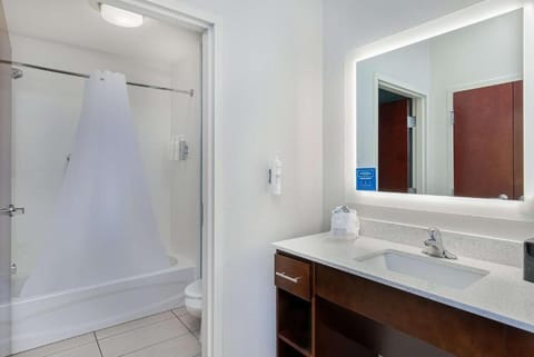 Rinse off comfortably with a clean tub-shower combo setup.