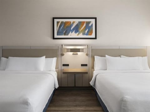 Drift off between crisp linens and soothing bedside lighting.