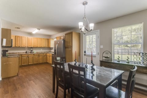 Share meals at the dining table with seating for six, steps from the kitchen.