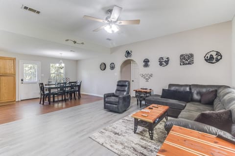 Gather in the spacious living room with sectional seating, sleek flooring, and bright natural light.