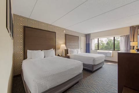 Spacious modern room with two queen beds, desk & large window with nature views