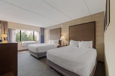 Spacious modern room with two queen beds, desk & large window with nature views