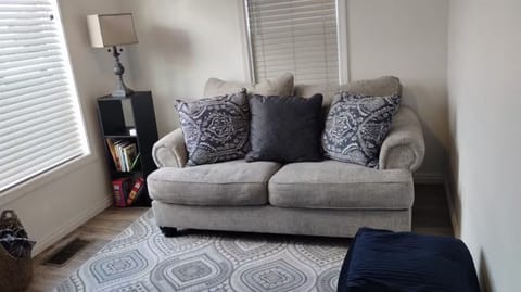 Living room with board games, books for  readers and a tv. 