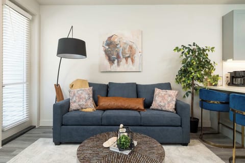 Inviting living room with a pull-out couch, a comfy chair and a flat-screen TV—perfect for relaxing or entertaining.