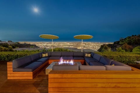 The fire pit area has a comfortable sectional and enjoys a beautiful city view.