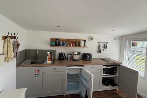 The fitted kitchen area with microwave convection oven and hob, fridge with freezer compartment, toaster, coffee maker and all the tableware, drinking ware and cookware you'll need