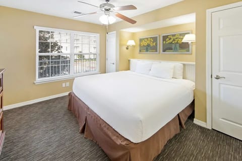 Unwind in a bright king bedroom with crisp linens.