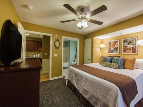 Stretch out in a warm bedroom with TV and lounge chair.