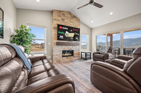 Gather with family in this spacious living room featuring mountain views and modern comfort.