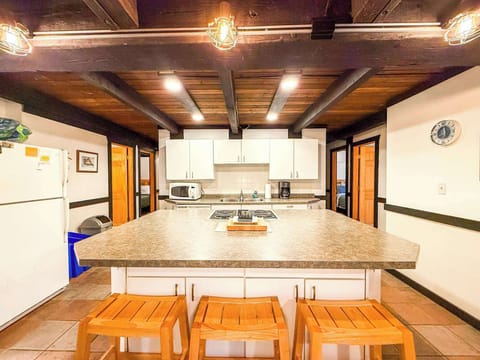 The large kitchen island has a built in stove and oven and three seats for a quick snack before you head out for your day.