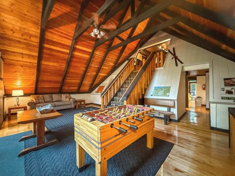 The large entryway doubles as a hang out space with a couch and foosball table.