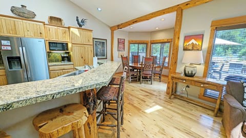 The open concept area includes the Kitchen, Dining, and Living areas