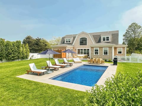 Backyard view of heated pool and spacious yard