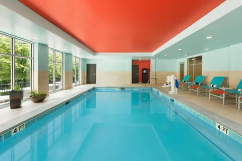 Dive into a sunlit indoor pool for refreshing relaxation.