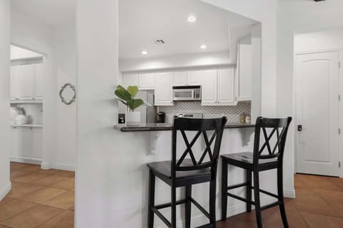 Counter-height breakfast bar adds extra seating for two more adults.