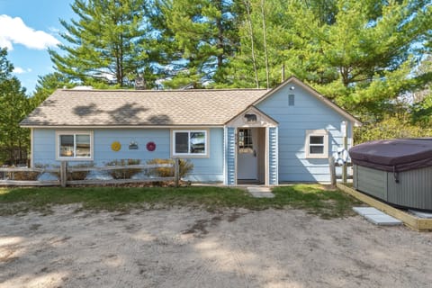Charming blue cottage tucked beneath the pines, with a private hot tub and easy lake-day vibes from the moment you arrive.