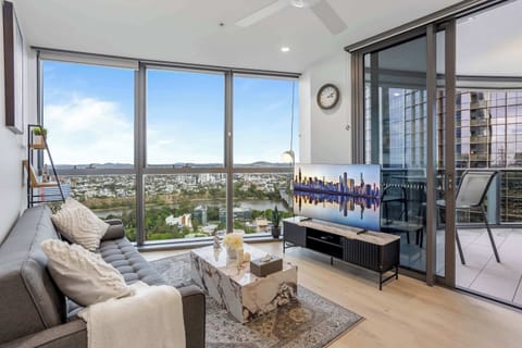 Long day exploring Brisbane? Come home to this inviting living room. Sink into the comfy sofa, slide open the doors to the balcony for evening views, or simply relax with the TV. Your perfect spot to unwind and recharge awaits after your city adventu