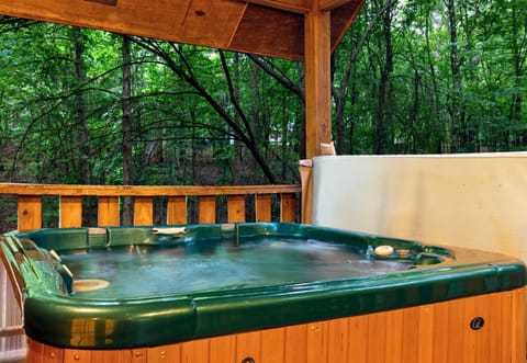 Soak in the hot tub as you overlook the pond—water views and woodland privacy combined.