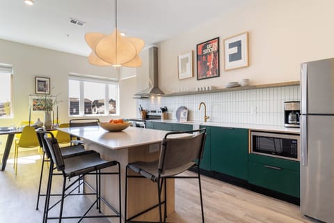 Fully equipped kitchen with a spacious island and barstool seating.