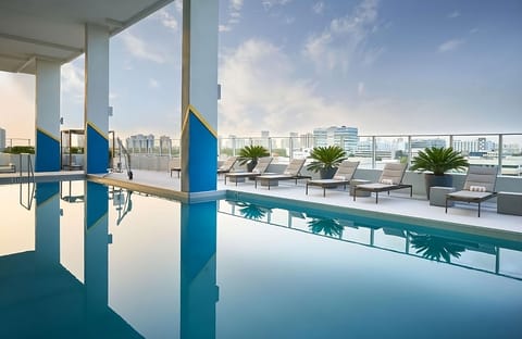 Float into a tranquil morning with airy rooftop pool serenity.