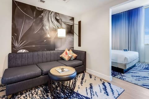 Stretch out on the plush sofa beside bold, artistic wall décor.
