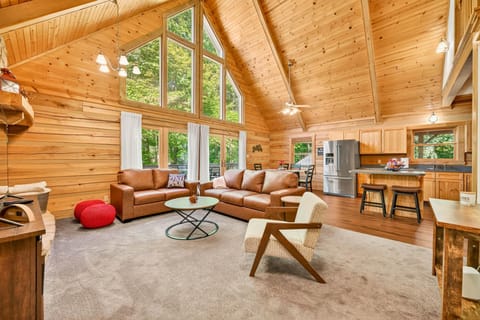 Spacious log cabin living room with vaulted ceilings and cozy seating