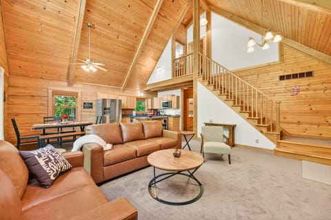 Spacious living room with vaulted ceilings and cozy leather seating