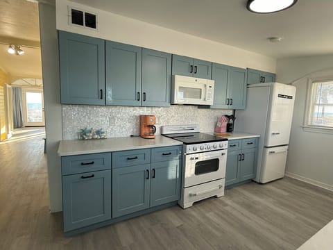 Blue Kitchen Cabinets with Retro Appliances and Mother of Pearl Backsplash!