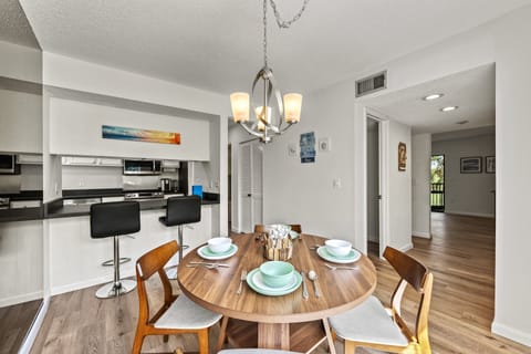 Open dining area flowing into the kitchen with a glimpse of the living room.
